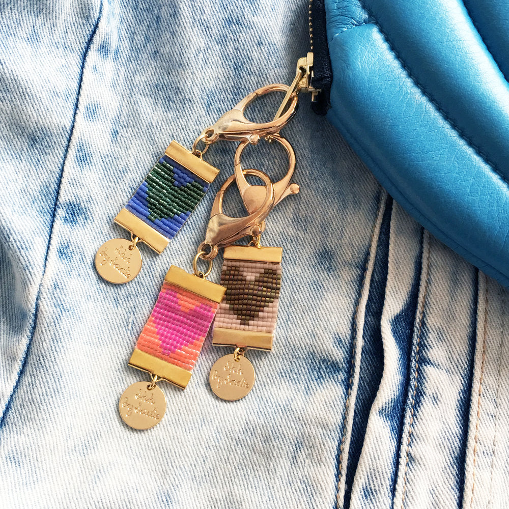 Colorful Charmed Heart Bag Charms - Handwoven with Gold Accents 
Discover the perfect spring accessory! These handwoven Charmed Heart bag charms come in various colors and feature 24 carat gold plated clamps and a chunky gold clasp Bijou Her