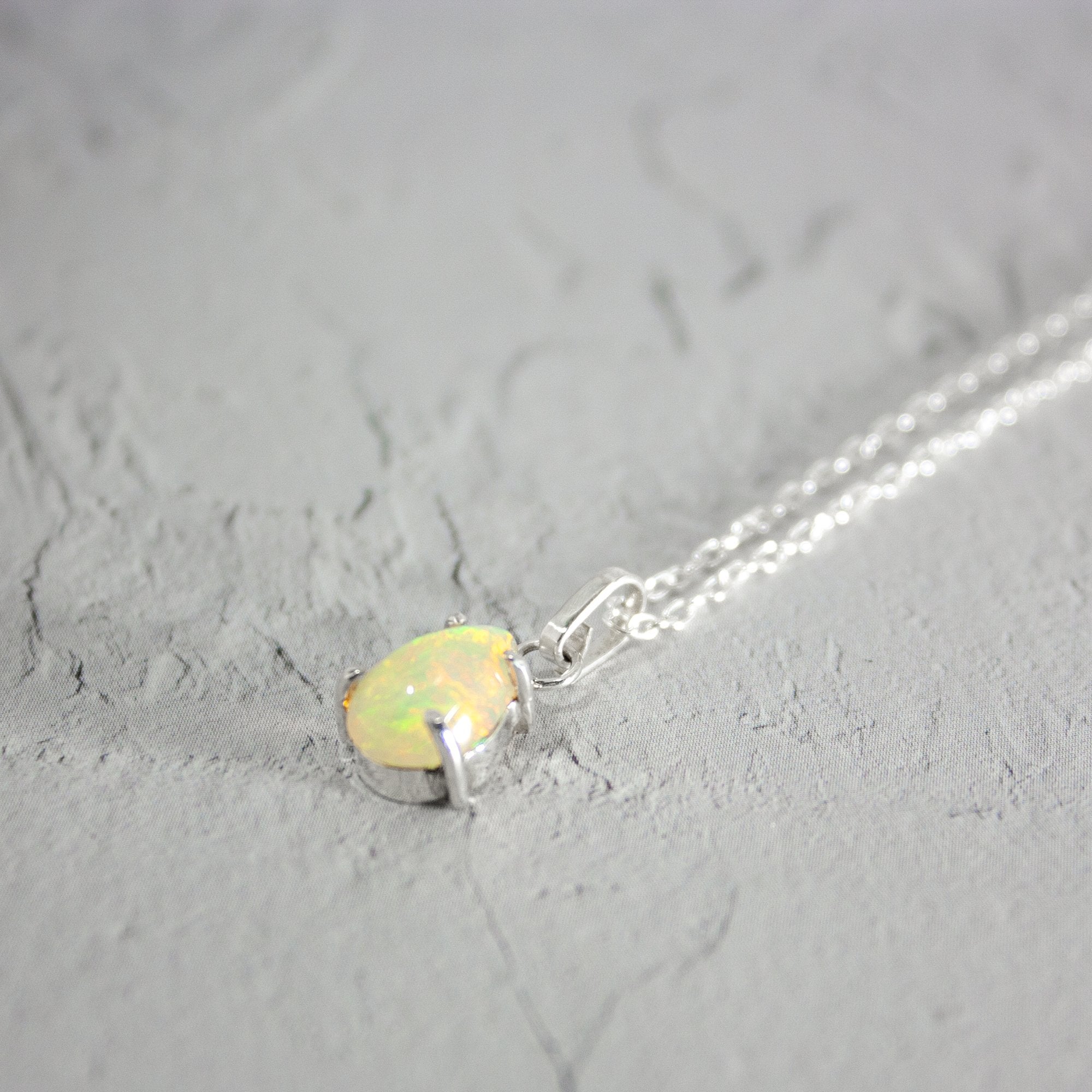 Ethereal Ethiopian Opal Pendant Necklace in Sterling Silver - 20" Length
Keywords: Ethiopian opal, pendant necklace, sterling silver, claw setting, mid length necklace, natural gemstones, mesmerizing colors. Bijou Her